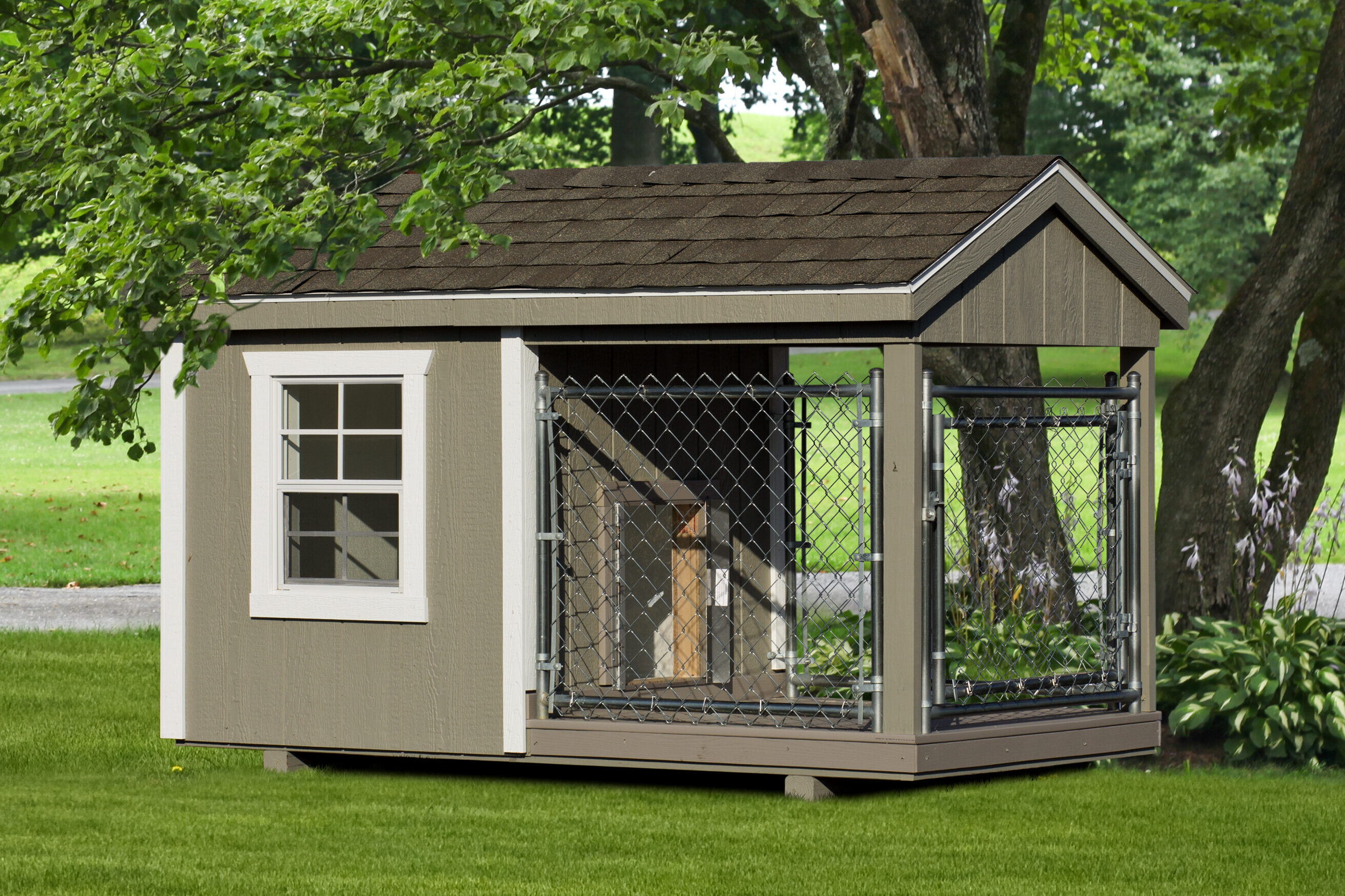 tan dog kennel with white trim and an attached run under a trim